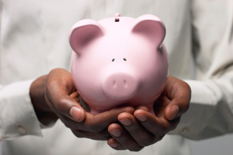 Man Holding Piggy Bank