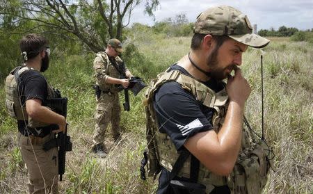 Members of the "Patriots" (L-R) Huggie Bear (not his real name), Will (no last name given) and Rob Chupp patrol on the U.S.-Mexico border outside Brownsville, Texas September 2, 2014. REUTERS/Rick Wilking