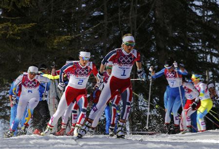 Norway's Therese Johaug (C) and Marit Bjoergen (centre L) ski ahead of the pack during the women's cross-country 30 km mass start free event at the Sochi 2014 Winter Olympic Games February 22, 2014. REUTERS/Carlos Barria