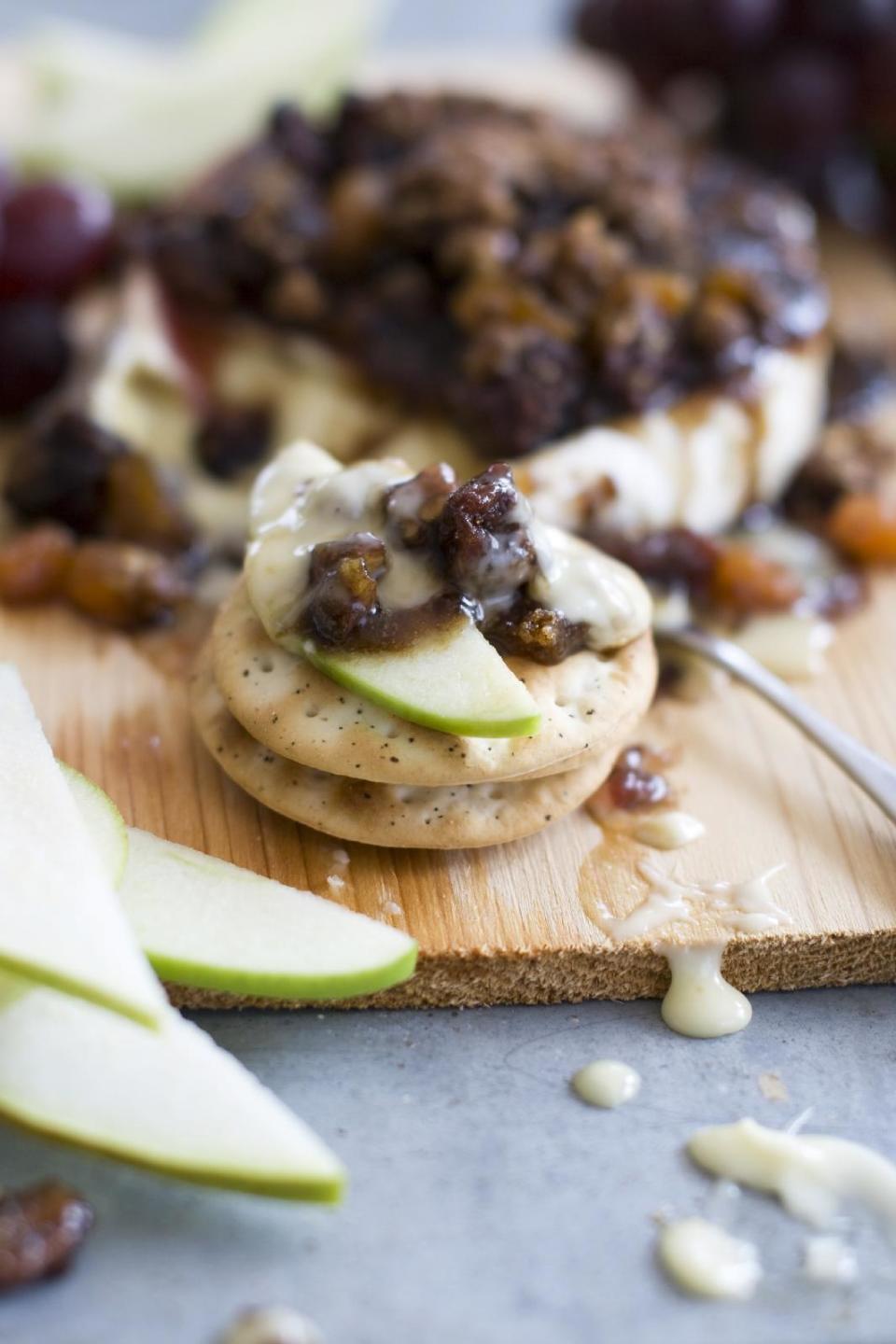 This April 1, 2013 photo taken in Concord, N.H. shows a recipe for cedar-planked pecan, bourbon and brown sugar glazed brie. (AP Photo/Matthew Mead)