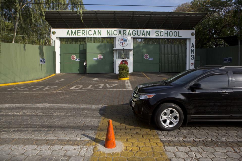 In this Wednesday, May 7, 2014 photo, a vehicle drives by the main entrance gate of the American Nicaraguan School in Managua, Nicaragua. U.S. citizen William James Vahey, 64, worked as teacher here from 2013-2014. He was one of the most beloved teachers in the world of international schools that serve the children of diplomats, well-off Americans and local elites. The FBI regards Vahey as one of the most prolific pedophiles in memory has set off a crisis in the community of international schools, where parents are being told that their children may have been victims, and administrators are scurrying to close loopholes exposed by Vahey’s abuses. (AP Photo/Esteban Felix)