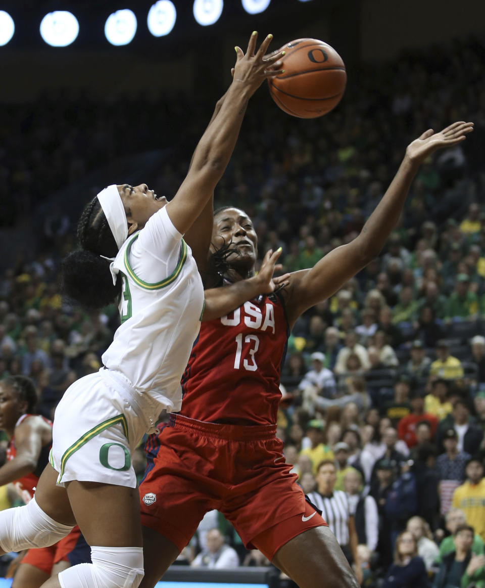 Oregon's Minyon Moore, left, is fouled while going to the basket by United States' Sylvia Fowles during the first half of an exhibition basketball game in Eugene, Ore., Saturday, Nov. 9, 2019. (AP Photo/Chris Pietsch)