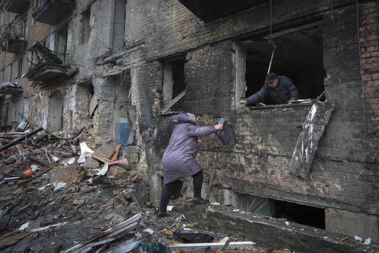 La gente toma sus pertenencias en una casa dañada después del bombardeo ruso en la ciudad de Vyshgorod, en las afueras de la capital, Kiev, Ucrania, el jueves 24 de noviembre de 2022.(Foto AP/Efrem Lukatsky)