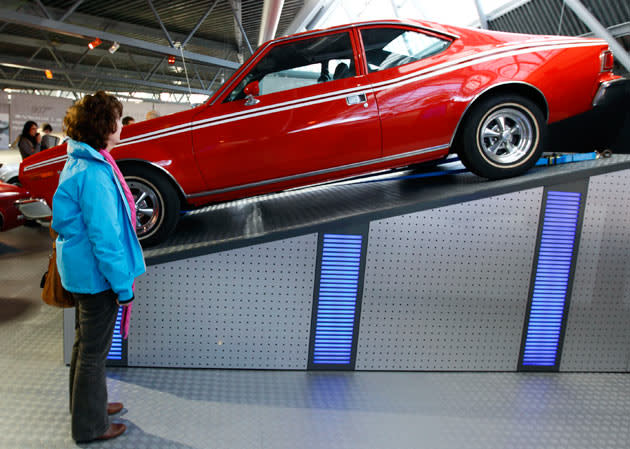 A woman looks at the ANC Hornet from the 1974 James Bond film "The Man With The Golden Gun" on display at the opening of a press preview of the Bond in Motion exhibition at the Beaulieu National Motor Museum at Brockenhurst in the southern English county of Hampshire on January 15, 2012. The Bond in Motion exhbition features fifty original iconic vehicles used in the James Bond films to celebrate fifty years of 007 and will open to the public from January 17. AFP PHOTO/ JUSTIN TALLIS