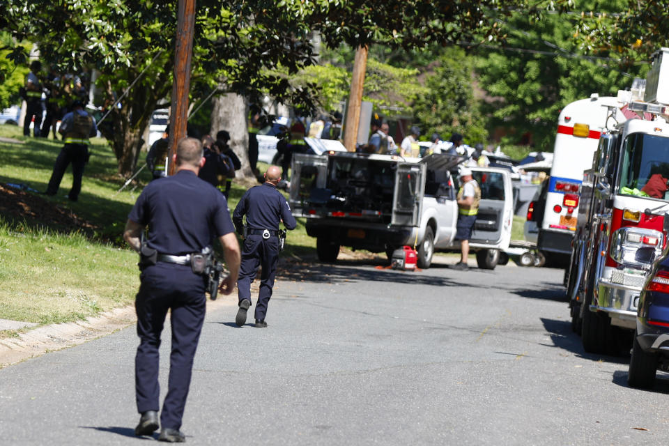 Charlotte Mecklenburg Police Department officers walk in the neighborhood where a shooting took place in Charlotte, N.C., Monday, April 29, 2024. The Charlotte-Mecklenburg Police Department says officers from the U.S. Marshals Task Force were carrying out an investigation Monday afternoon in a suburban neighborhood when they came under gunfire. (AP Photo/Nell Redmond)