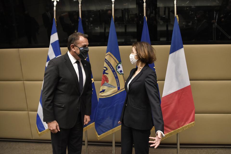 French Defense Minister Florence Parly, right, and his Greek counterpart Nikos Panagiotopoulos speak during their meeting in Athens, Monday, Jan. 25, 2021. Greece is due to sign a 2.3 billion euro ($2.8 billion) deal with France Monday to purchase 18 Rafale fighter jets to address tension with neighbor Turkey. (Louisa Gouliamaki/Pool via AP)