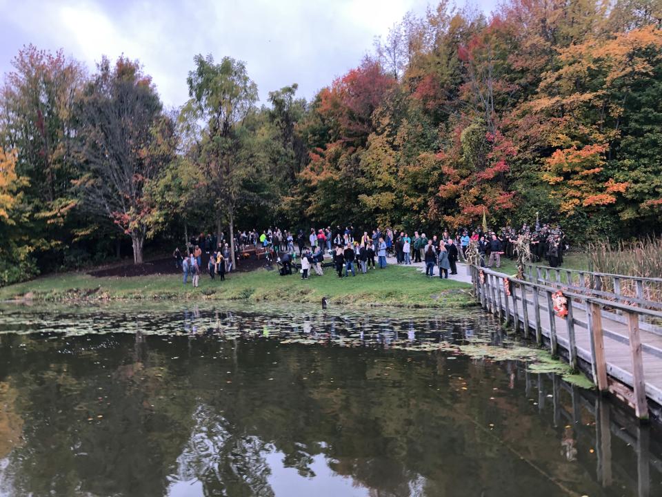 Dozens gather by the Worster Lake shoreline for the groundbreaking for an inn at Potato Creek State Park in North Liberty on Thursday, Oct. 19, 2023.