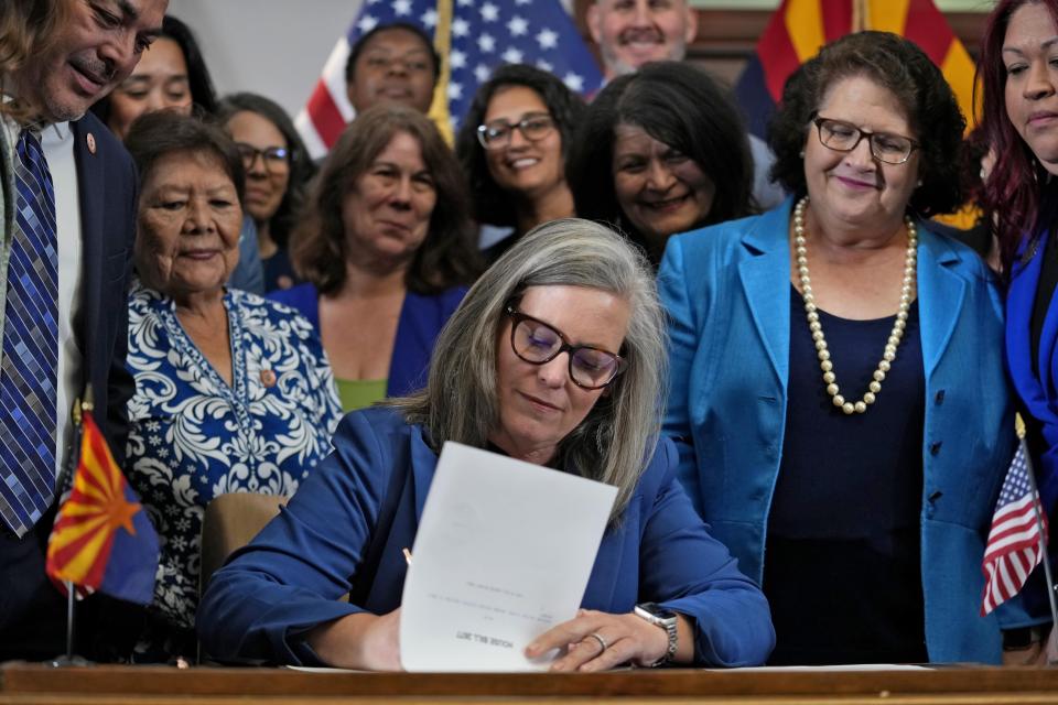 Arizona Gov. Katie Hobbs, D, signs the repeal of the Civil War-era near-total abortion ban, Thursday, May 2, 2024, at the Capitol in Phoenix. Democrats secured enough votes in the Arizona Senate to repeal the ban on abortions that the state's highest court recently allowed to take effect. (AP Photo/Matt York)