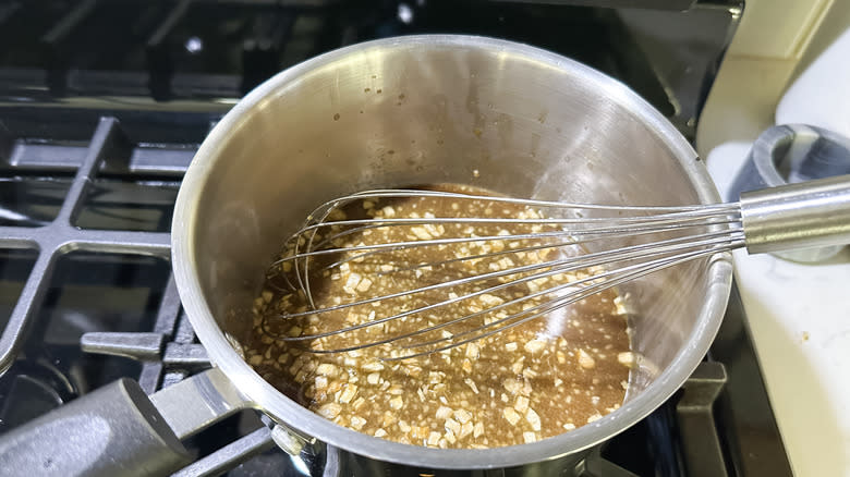 whisking teriyaki sauce on stove