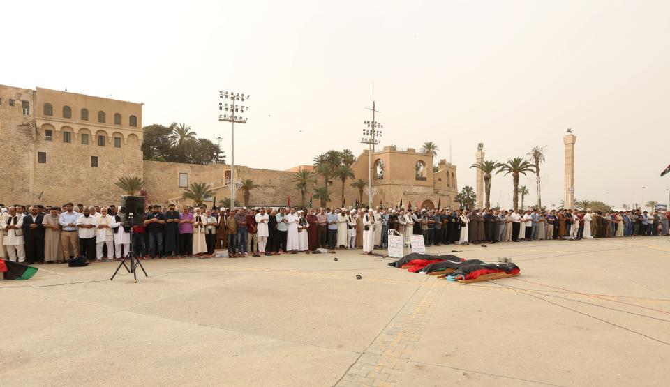 Mourners gather for funeral prayers for fighters killed by warplanes of Field Marshal Khalifa Hifter's forces, Wednesday, April 24, 2019 in Tripoli, Libya. A top Russian diplomat has called on the self-styled Libyan National Army to cease fire and stop its advance on the Libyan capital.(AP Photo/Hazem Ahmed)