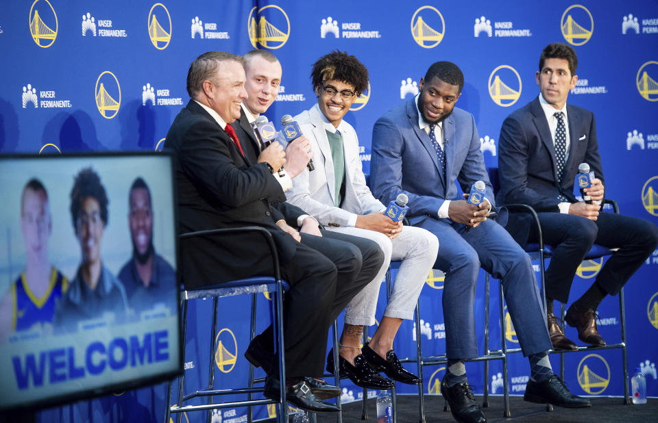 Golden State Warriors NBA basketball draft picks attend a media conference with team leaders Monday, June 24, 2019, in Oakland, Calif. From left to right, are: Warriors broadcaster Bib Fitzgerald, Alen Smailagic, Jordan Poole, Eric Paschall and general manager Bob Myers. (AP Photo/Noah Berger)