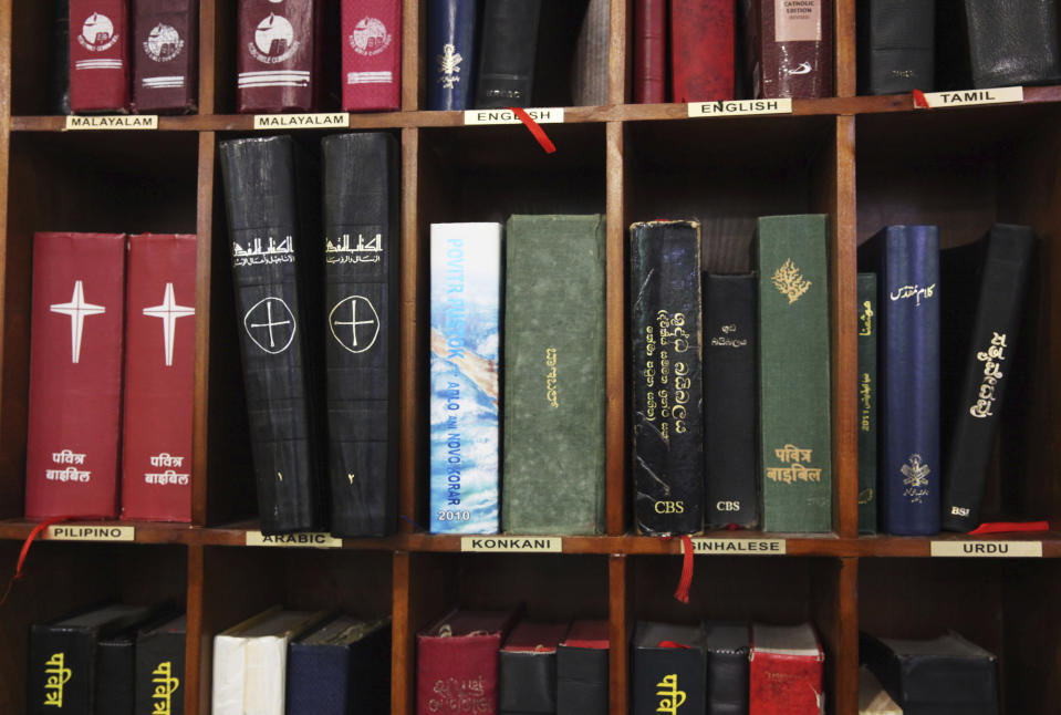 In this Sunday, Jan. 20, 2019 photo, Bibles and religious books in various languages are displayed on a bookshelf at St. Mary's Catholic Church in Dubai, United Arab Emirates. The diversity among its parishioners can be seen in its pews and heard the sermons of St. Mary’s priests, who celebrate Mass and offer prayers in Arabic, English, French, Tagalog, Tamil, Urdu and other languages. Pope Francis’ visit to the United Arab Emirates starting Sunday Feb. 3, marks the first ever papal visit to the Arabian Peninsula, the birthplace of Islam. (AP Photo/Jon Gambrell)