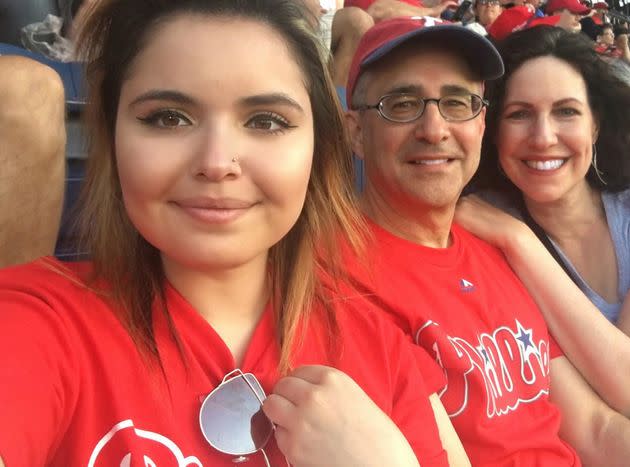 The author and her husband with Sammie cheering on the Phillies at Citizens Bank Park in 2019.