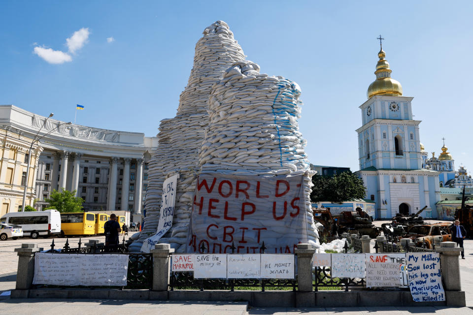 FILE - Sand bags protect the Monument to Princess Olga, St. Andrew the Apostle and the educators Cyril and Methodius in Kyiv, Thursday, June 16, 2022. War has been a catastrophe for Ukraine and a crisis for the globe. One year on, thousands of civilians are dead, and countless buildings have been destroyed. Hundreds of thousands of troops have been killed or wounded on each side. Beyond Ukraine’s borders, the invasion shattered European security, redrew nations’ relations with one another and frayed a tightly woven global economy. (Ludovic Marin, Pool via AP, File)