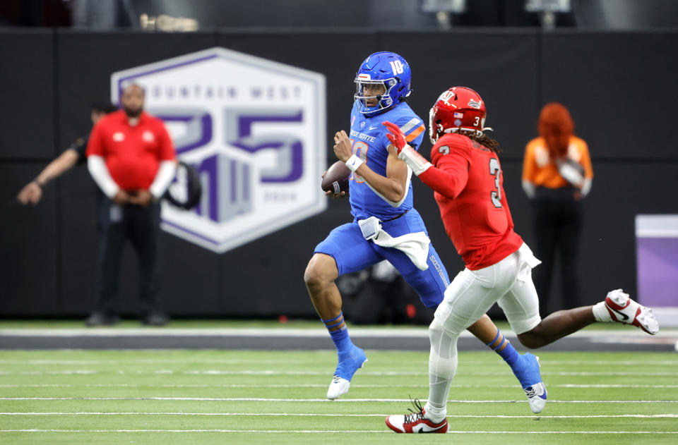 Boise State quarterback Taylen Green (10) scrambles under pressure from UNLV defensive back Johnathan Baldwin (3) during the first half of the Mountain West championship NCAA college football game Saturday, Dec. 2, 2023, in Las Vegas. (Steve Marcus/Las Vegas Sun via AP)