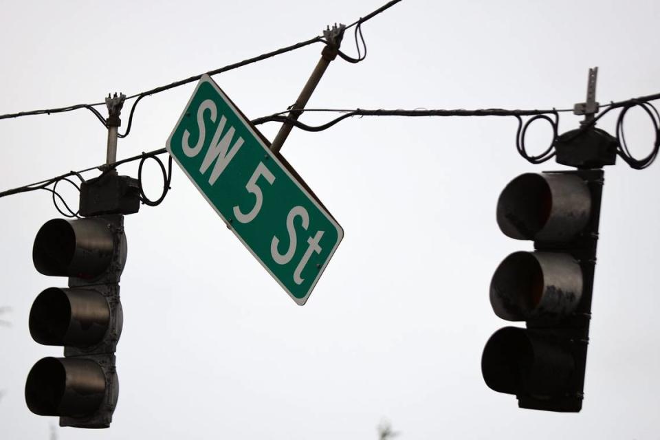 The traffic light is damaged as the street signed dangles at the intersection of SW 5th Street and SW 136th Ave at the entrance of Sunshine Village. A tornado possibly spawned by Hurricane Ian caused downed trees, traffic lights, and damage to property in and around Sunshine Village, a mobile home park in Davie, Florida on Wednesday, September 28, 2022.