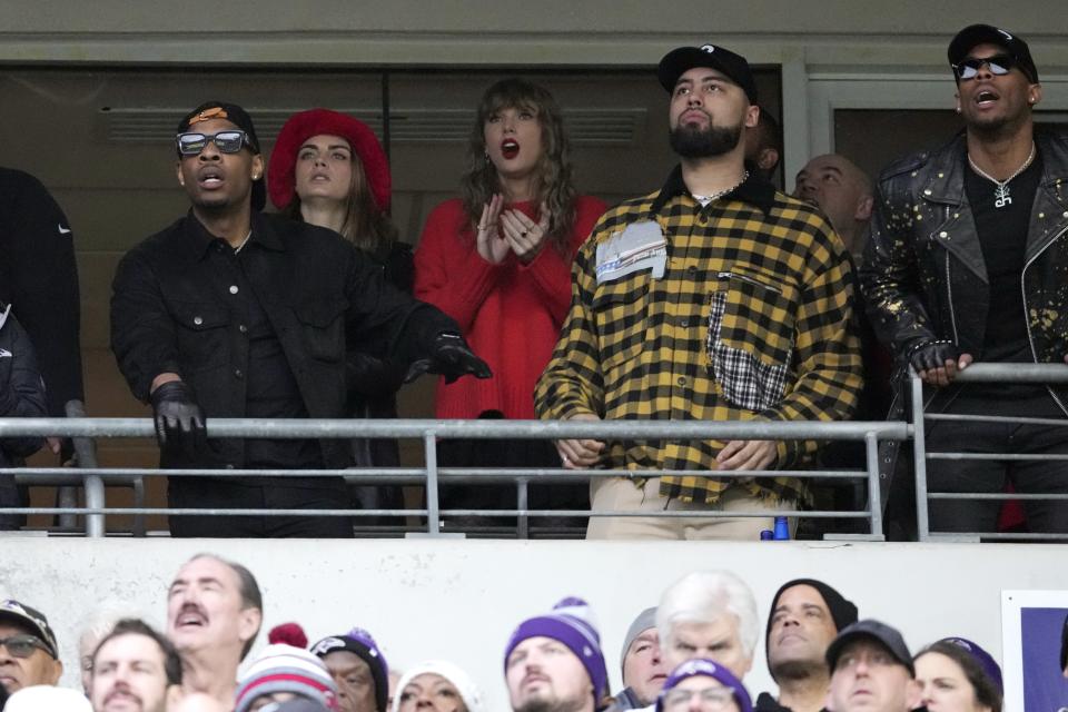 Cara Delevingne, second from left, and Taylor Swift, center, react during the first half of the AFC Championship NFL football game between the Baltimore Ravens and the Kansas City Chiefs, Sunday, Jan. 28, 2024, in Baltimore. (AP Photo/Nick Wass)