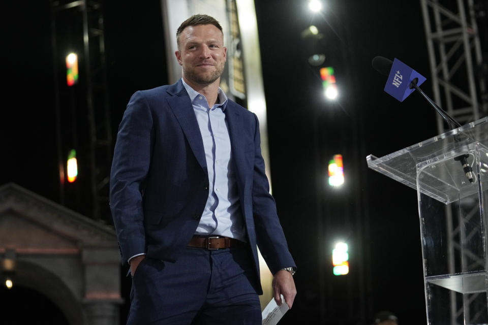 New Orleans Saints quarterback Taysom Hill announces a pick for the New Orleans Saints during the second round of the NFL football draft, Friday, April 26, 2024, in Detroit. (AP Photo/Jeff Roberson)