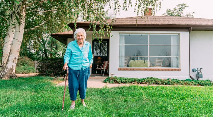 A woman stands outside the home that she transferred to an irrevocable trust to qualify for Medicaid. 