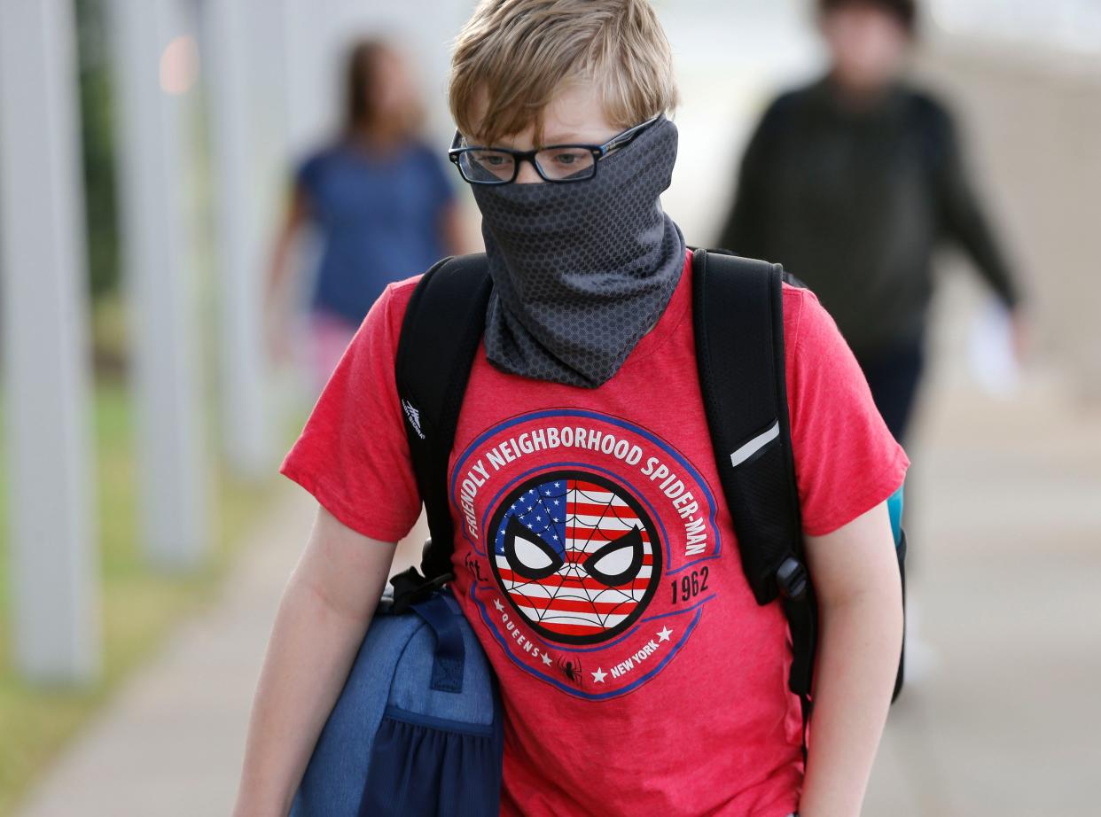 Carson Grantham wears his face mask as he enters the new Northport Intermediate School on Thursday, Aug. 12, 2021.[Staff Photo/Gary Cosby Jr.]