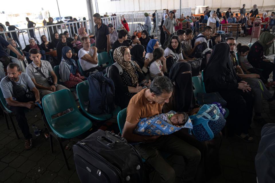 Palestinians wait to cross into Egypt.