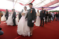 Lesbian couple Chen Ying-hsuan, right, and Li Li-chen attend a military mass weddings ceremony in Taoyuan city, northern Taiwan, Friday, Oct. 30, 2020. Two lesbian couples tied the knot in a mass ceremony held by Taiwan's military on Friday in a historic step for the island. Taiwan is the only place in Asia to have legalized gay marriage, passing legislation in this regard in May 2019. (AP Photo/Chiang Ying-ying)