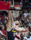 Portland Trail Blazers center Jusuf Nurkic, right, tips the ball in over Denver Nuggets center Nikola Jokic during the second half of an NBA basketball game in Portland, Ore., Monday, Oct. 24, 2022. (AP Photo/Craig Mitchelldyer)