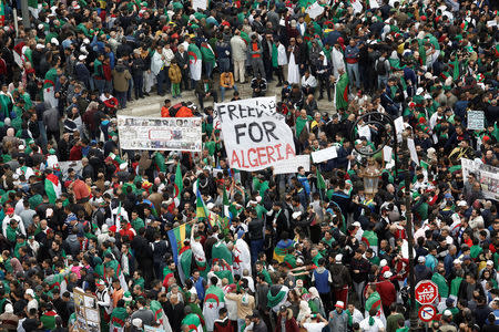 Demonstrators hold banners as they return to the streets to press demands for wholesale democratic change well beyond former president Abdelaziz Bouteflika's resignation, in Algiers, Algeria April 19, 2019. REUTERS/Ramzi Boudina