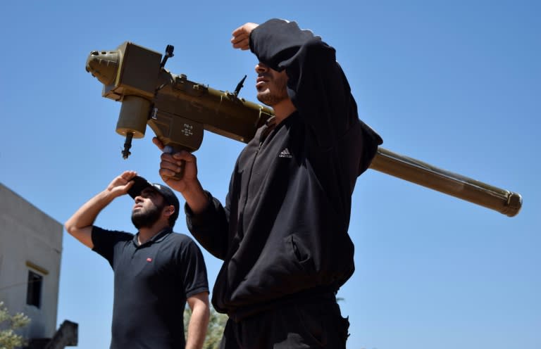 Rebel fighters monitor the sky holding a FN-6 man-portable air-defence system (MANPADS) in the Syrian village of Teir Maalah in 2016 (MAHMOUD TAHA)