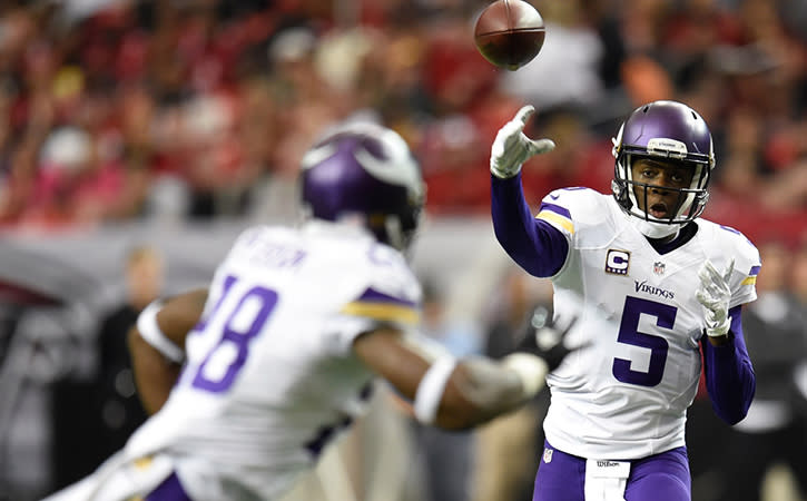 Minnesota Vikings quarterback Teddy Bridgewater passes to running back Adrian Peterson against the Atlanta Falcons.