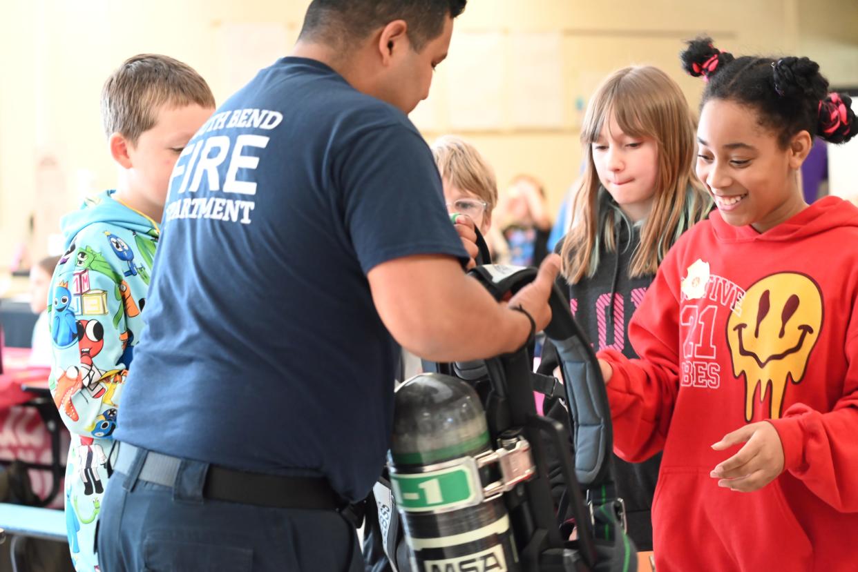 Darden Elementary fifth grader Tinayia tries on the South Bend Fire Department's self-contained breathing apparatus gear on May 10, 2024 at 18645 Janet Drive.