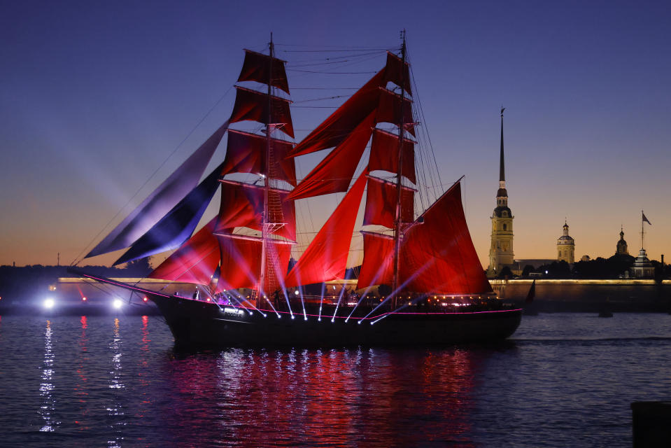 A brig with scarlet sails, sailing on the Neva River during the Scarlet Sails festivities marking school graduation in St. Petersburg, Russia, early Saturday, June 25, 2022. (AP Photo/Elena Ignatyeva)