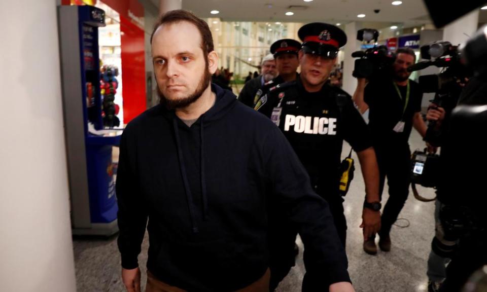 Joshua Boyle walks through the airport after arriving with his wife and three children in Toronto.