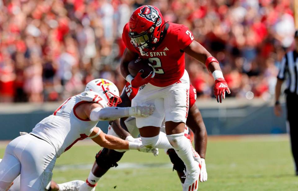 N.C. State running back Michael Allen (2) tries to break free from Virginia Military Institute defensive back Josh Knapp (17) during the first half of N.C. State’s game against VMI at Carter-Finley Stadium in Raleigh, N.C., Saturday, Sept. 16, 2023.