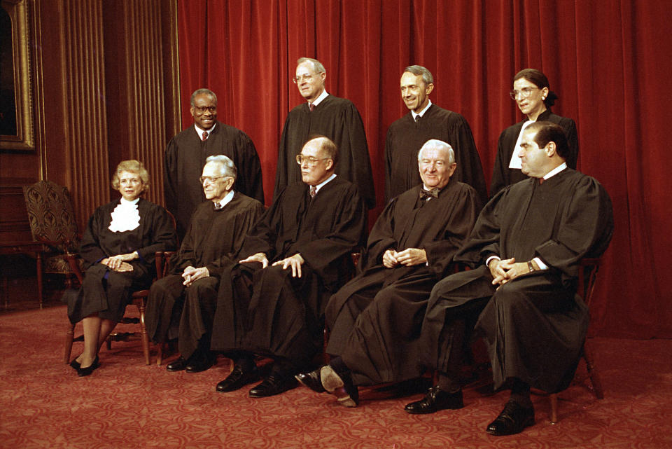 Members of the U.S. Supreme Court pose for their group portrait in Washington. Standing, from left: Associate Justices Clarence Thomas, Anthony M. Kennedy, David Souter, and Ruth Bader Ginsburg. Seated, from left are: Sandra Day O’Connor, Harry Blackmun, Chief Justice William Rehnquist, John Paul Stevens and Antonin Scalia. (Photo: Marcy Nighswander/AP)