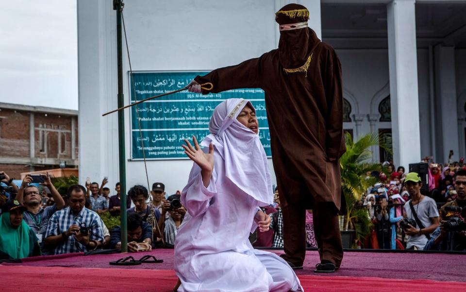 A woman gets caned in public for spending time with a man who is not her husband - Credit: GETTY