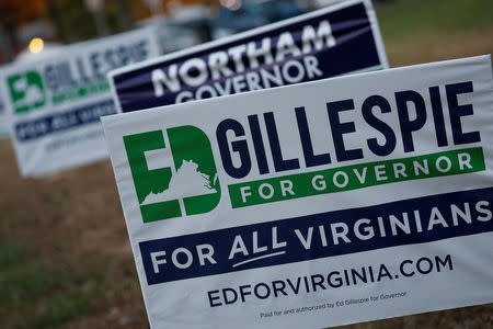 Campaign signs for Ed Gillespie and Ralph Northam are seen on Election Day at Washington Mill Elementary School in Alexandria, Virginia, U.S., November 7, 2017. REUTERS/Aaron P. Bernstein