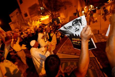 Protesters holding photos of Bahrain's leading Shi'ite cleric Isa Qassim shout religious slogans during a sit-in outside his home in the village of Diraz west of Manama, Bahrain July 27, 2016. REUTERS/Hamad I Mohammed