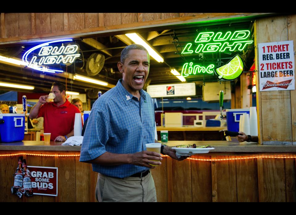  Obama gets a beer and a pork chop as he visits the Iowa State Fair in Des Moines on August 13, 2012 during an unannounced stop on his three-day campaign bus tour. AFP PHOTO/Jim WATSON  