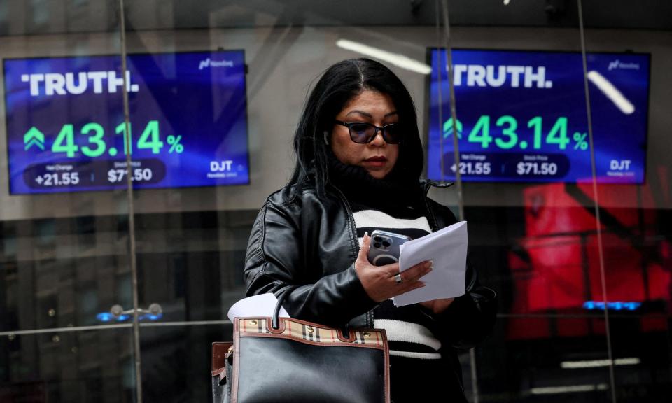 <span>Truth Social trading data on screens outside the Nasdaq building in New York on Tuesday.</span><span>Photograph: Brendan McDermid/Reuters</span>