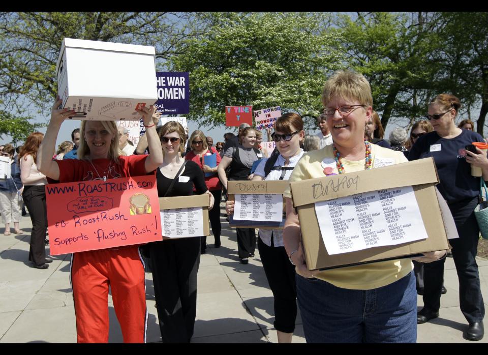 Protesters carry boxes containing petition signatures Wednesday, March 28, 2012, in Jefferson City, Mo. The protesters delivered 35,000 petition signatures Wednesday to the House speaker's office opposing the inclusion of conservative talk show host Rush Limbaugh in the Hall of Famous Missourians in the latest in a series of opposition efforts to Limbaugh's selection. (AP Photo/Jeff Roberson)