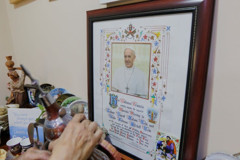 Najla Uchi shows a letter send to her by Pope Francis in her home in Manama