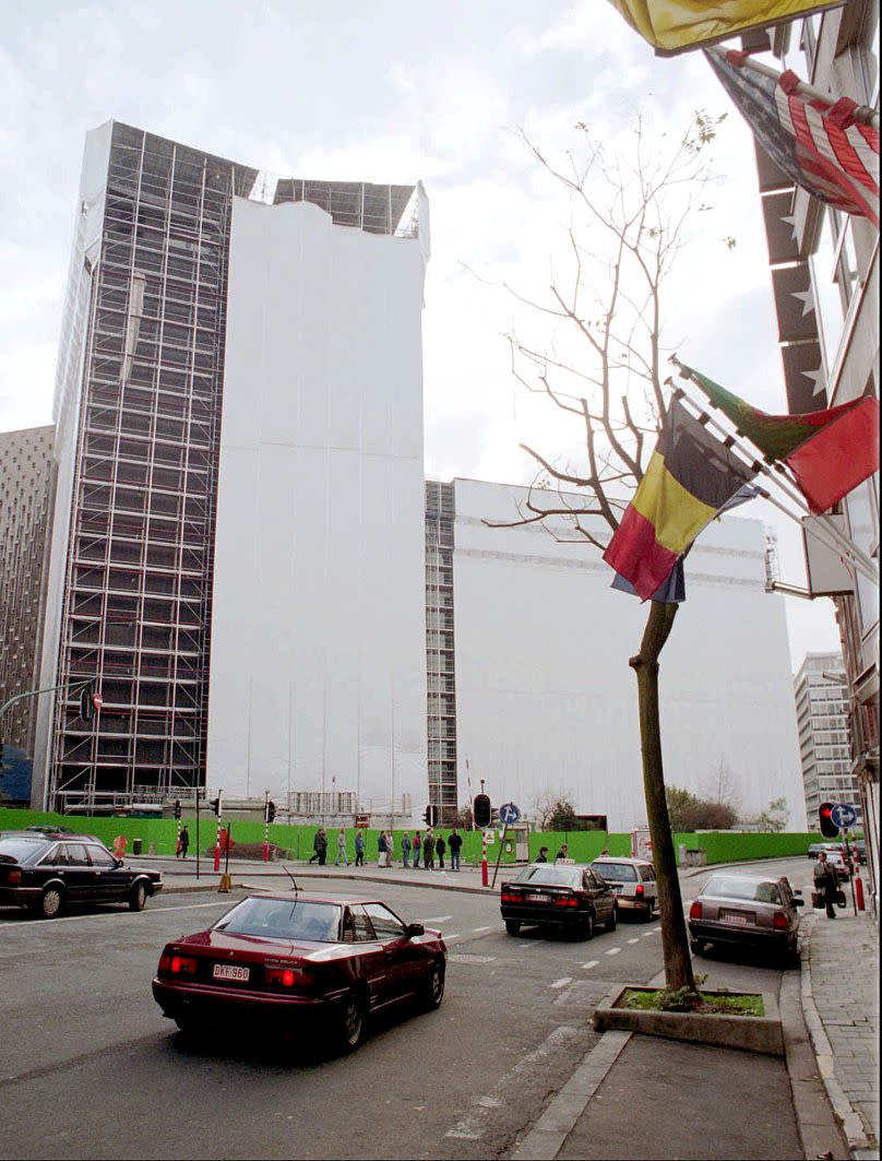 The European Commission's Berlaymont building partially wrapped in plastic sheeting in preparation for asbestos removal, in Brussels, November 1995