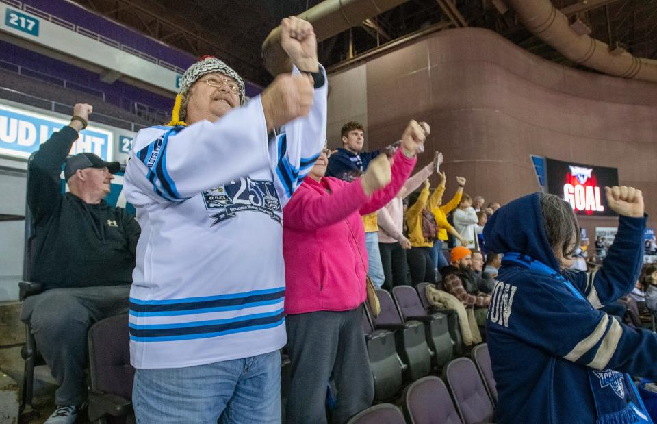 Ralph Overly, front, and fellow fans do their celebration dance after an Ice Flyers goal during the Peoria Rivermen vs Pensacola Ice Flyers ice hockey game in Pensacola on Thursday, Jan. 4, 2024.