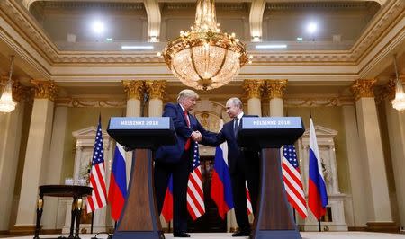 U.S. President Donald Trump and Russia's President Vladimir Putin shake hands during a joint news conference after their meeting in Helsinki, Finland, July 16, 2018. REUTERS/Kevin Lamarque/Files