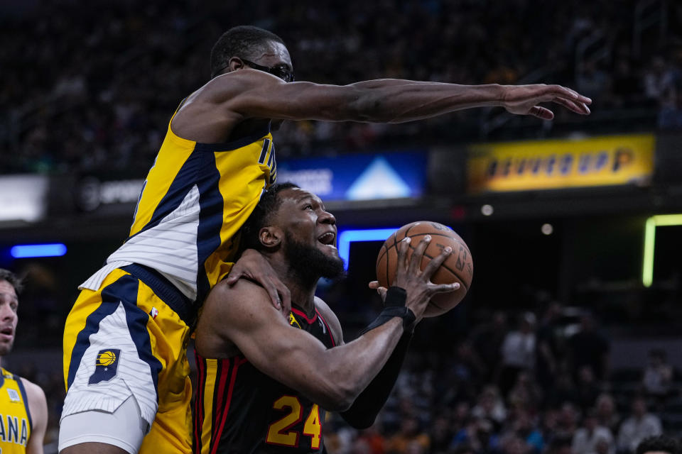 Indiana Pacers forward Jalen Smith (25) fouls Atlanta Hawks forward Bruno Fernando (24) during the first half of an NBA basketball game in Indianapolis, Sunday, April 14, 2024. (AP Photo/Michael Conroy)