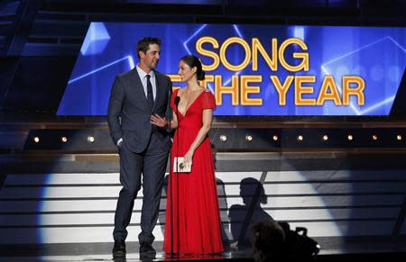 NFL football player Aaron Rogers and actress Olivia Munn present the Song of the Year Award on stage at the 49th Annual Academy of Country Music Awards in Las Vegas, Nevada April 6, 2014. REUTERS/ Robert Galbriath