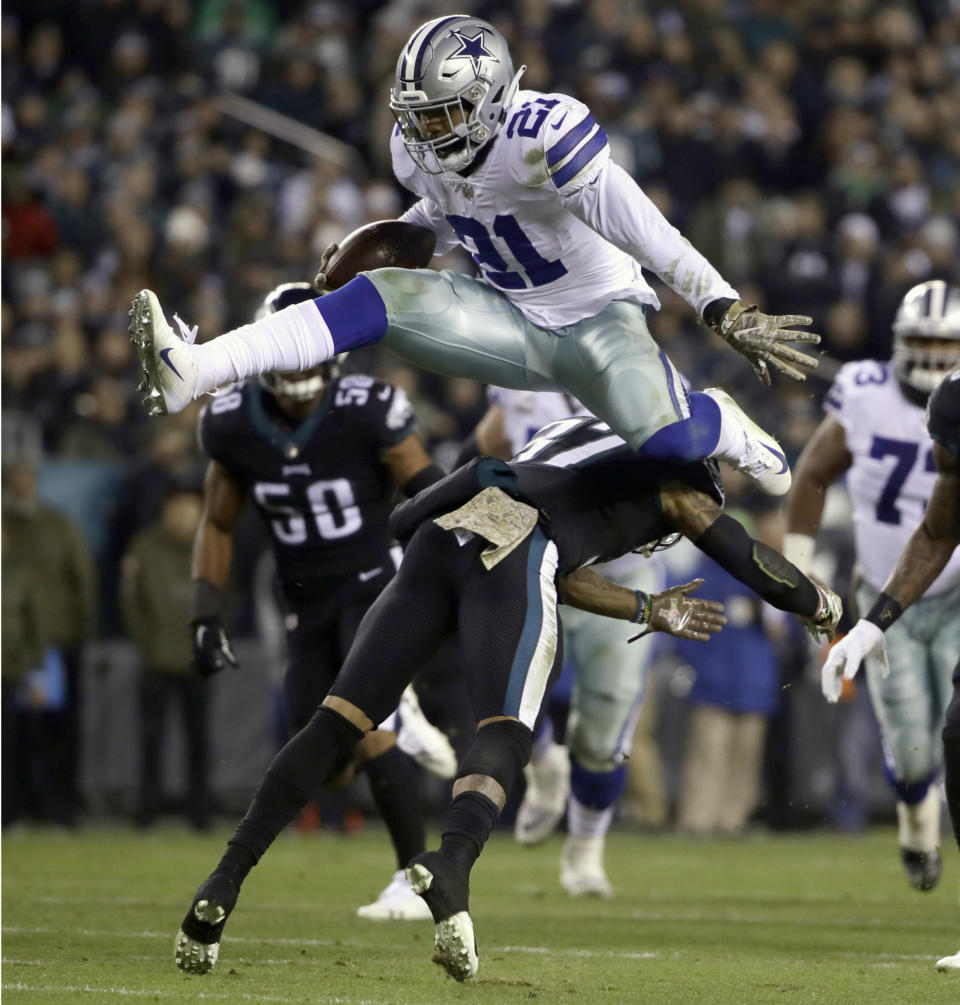 FILE - In this Nov. 11, 2018, file photo, Dallas Cowboys running back Ezekiel Elliott (21) hurdles over Philadelphia Eagles defensive back Tre Sullivan (37) during the first half of an NFL football game, in Philadelphia. Todd Gurley is a big football fan, and Elliott is one of his favorite players. The good feelings are mutual heading into the Cowboys' playoff visit to the Rams and a showdown between the NFL's two premiere running backs. (AP Photo/Matt Rourke, File)