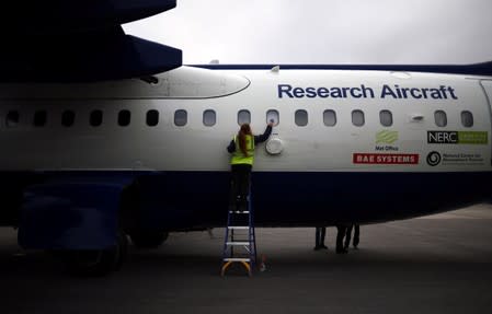 Dominika Pasternak, a Polish PhD student in atmospheric chemistry at Britain's University of York, cleans the window of an atmospheric research aircraft ahead of its departure from Kiruna airport in Kiruna