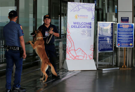 An airport policeman with a sniffing dog stands on guard beside the Association of Southeast Asian Nations (ASEAN) sign at the departure area of the Ninoy Aquino International Airport (NAIA) in Pasay City, Metro Manila, Philippines April 27, 2017. REUTERS/Romeo Ranoco